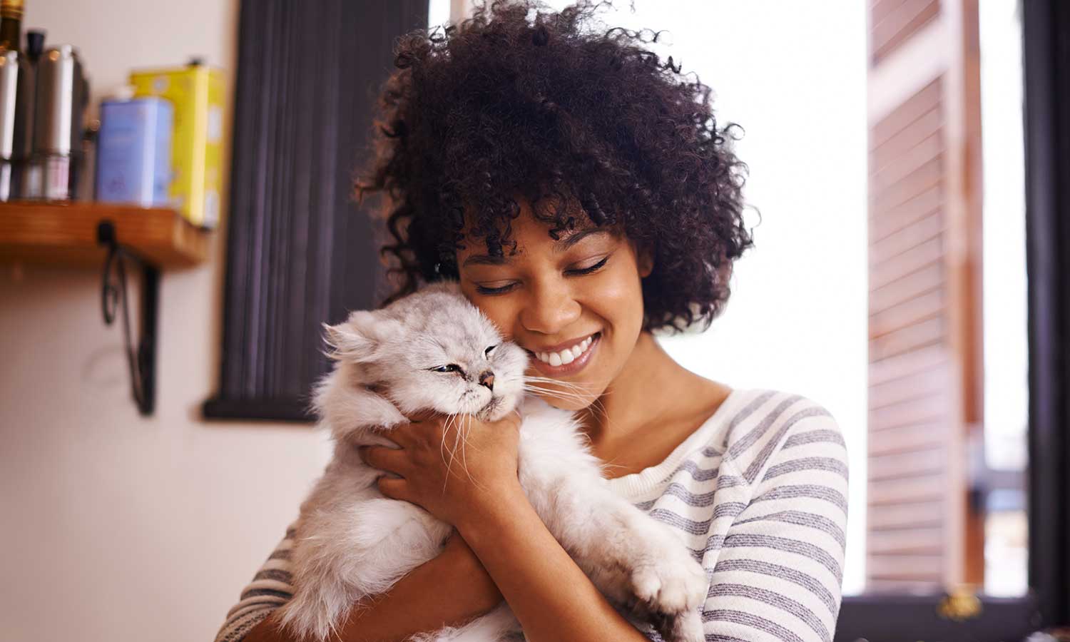 A woman cuddling her cat